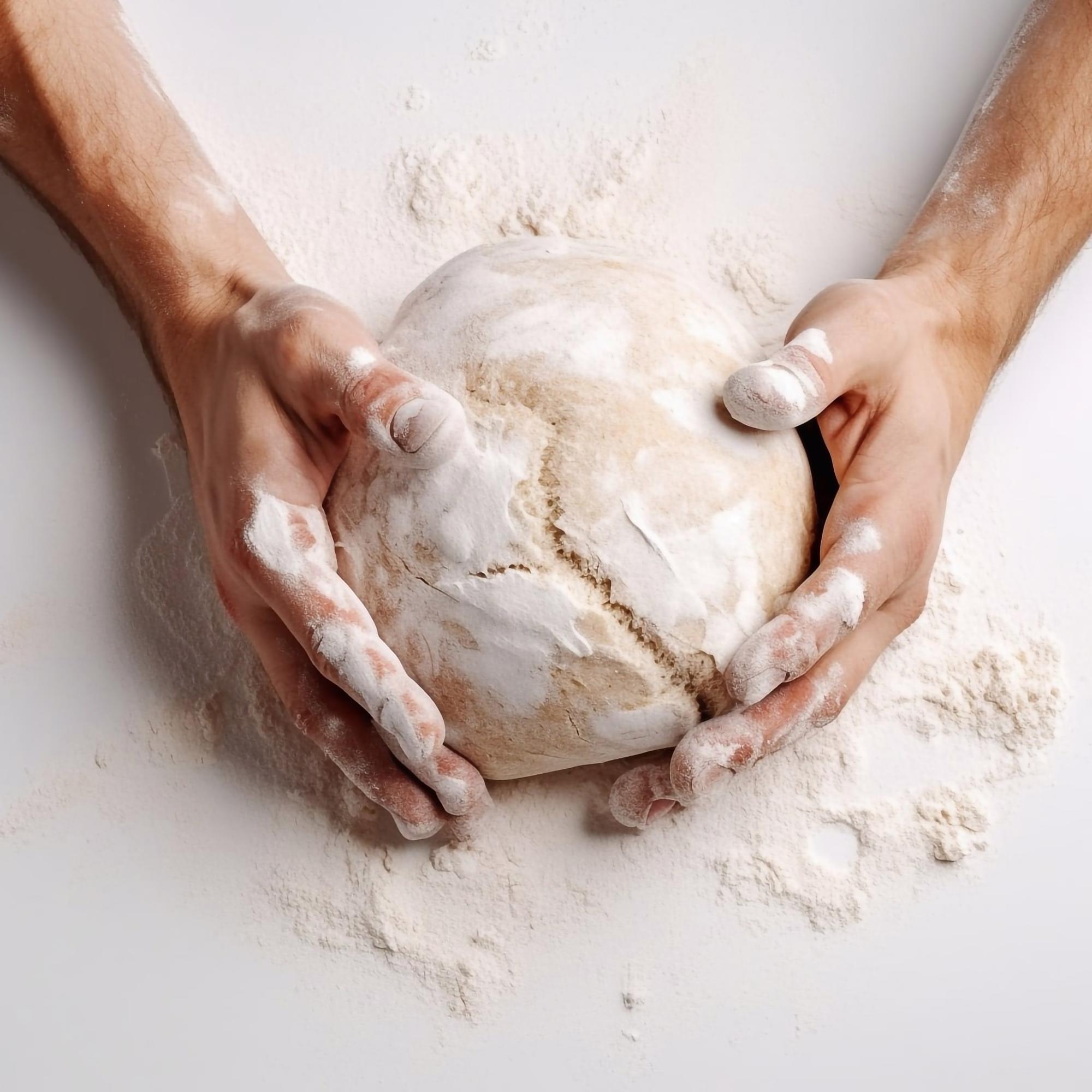 Close-up of hands kneading artisanal dough